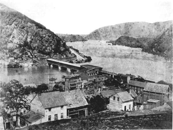 Figure 8.&mdash;The Baltimore and Ohio Railroad&rsquo;s Potomac
River crossing at Harpers Ferry, about 1860. Bollman&rsquo;s iron &ldquo;Winchester
span&rdquo; of 1851 is seen at the right end of Latrobe&rsquo;s timber structure of
1836, which forms the body of the bridge. (Photo courtesy of Harpers
Ferry National Historical Park.)